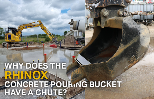 Yellow komatsu excavator filling up a concrete pouring bucket with concrete from a truck before pouring in the background. An empty rhinox concrete pouring bucket in the foreground