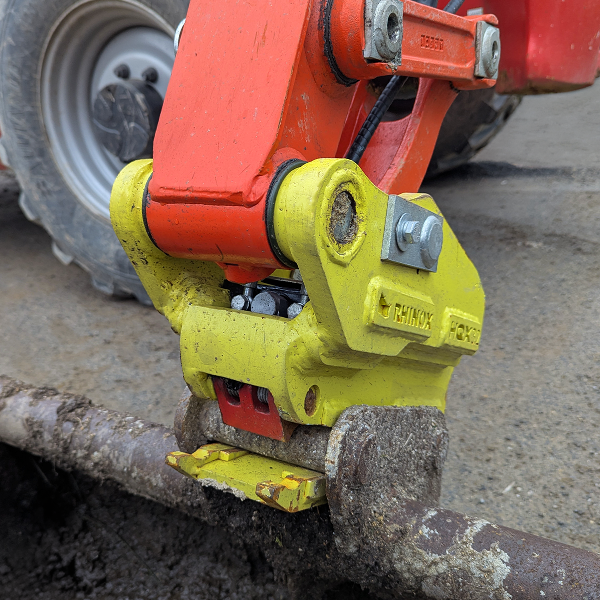 2-3T Fabricated Quick Hitch Lifestyle Image - mounted with a bucket