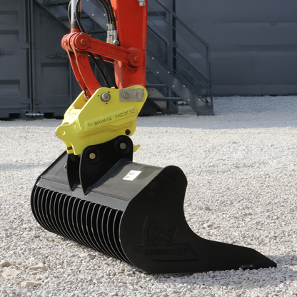 2-3T Fabricated Quick Hitch Lifestyle Image 2 - mounted with a rake riddle bucket