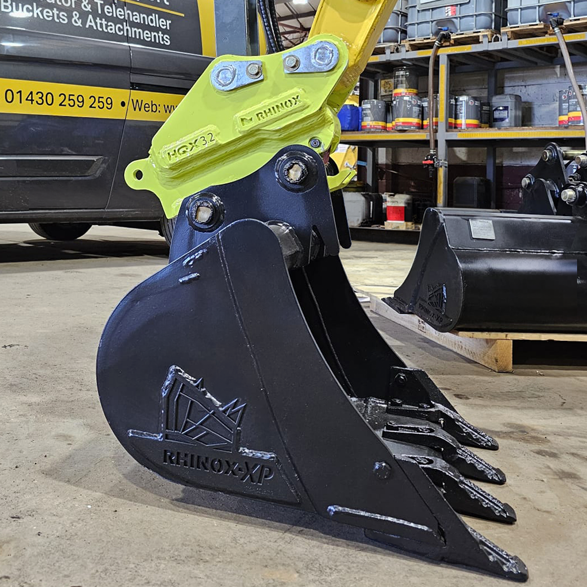 2-3T Fabricated Quick Hitch Lifestyle Image 3 - mounted with a digging bucket